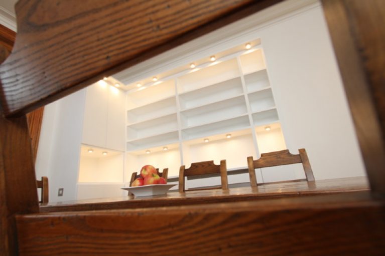 Wood table with white light storage behind